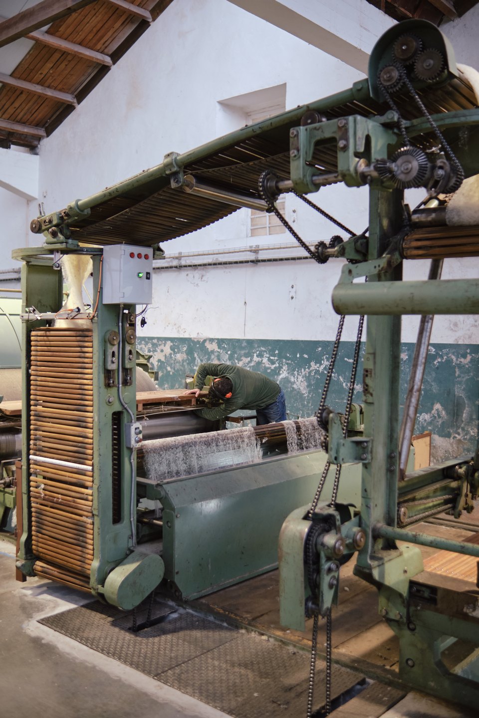 This machine takes in raw washed wool and aligns the fibers into a line that will later be used for burel. Photo taken at Burel Factory