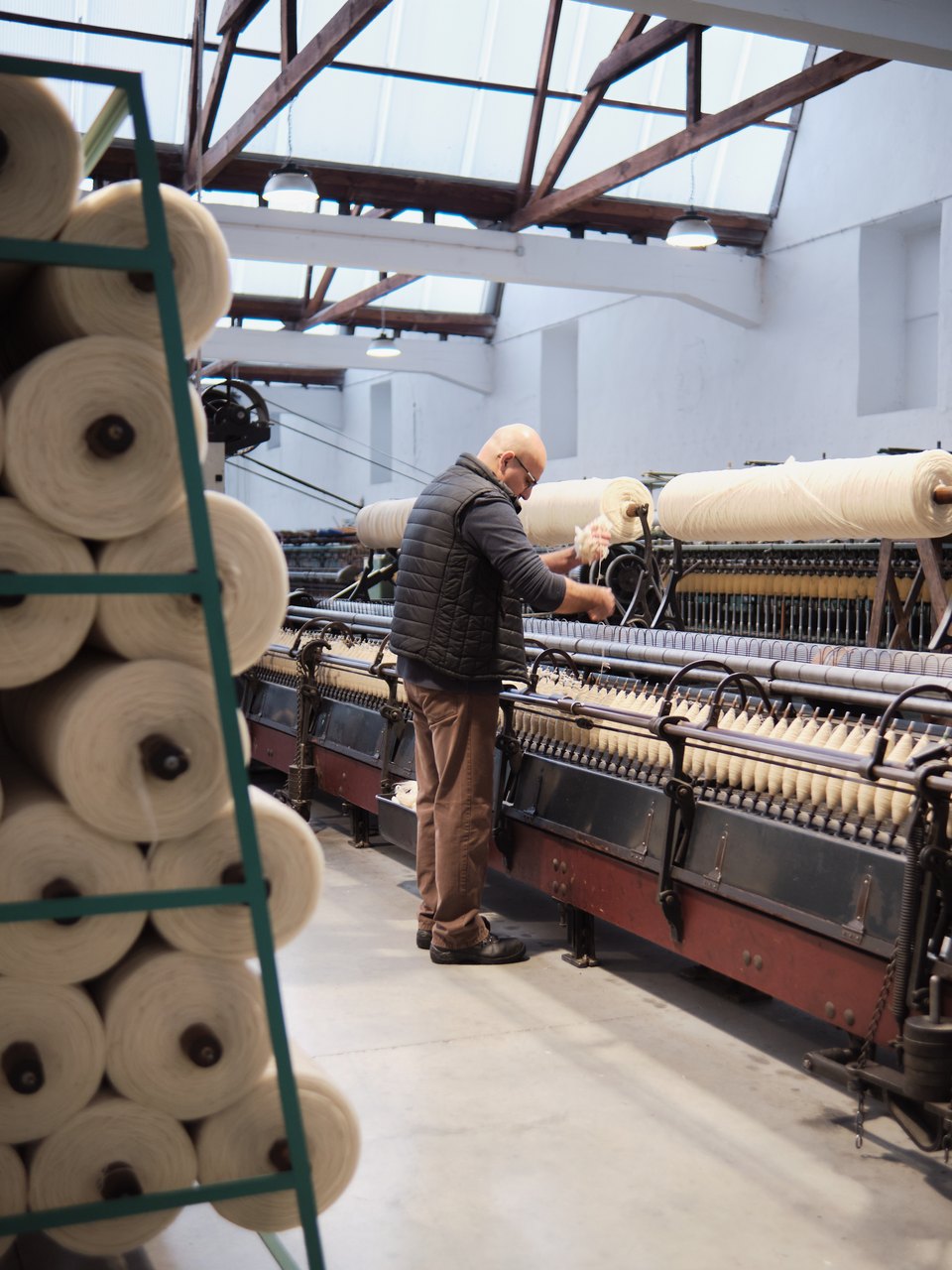 Large spools of yarn are divided into smaller spools. Photo taken at Burel Factory